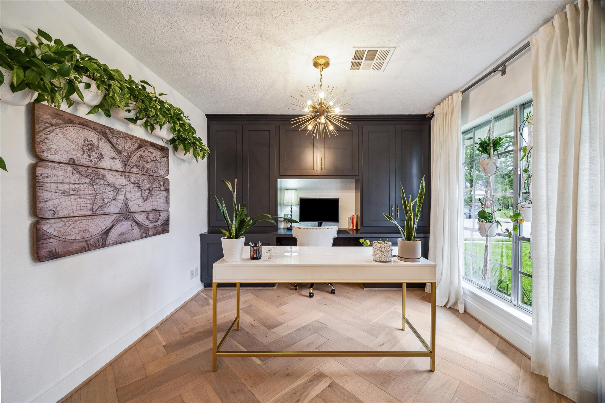 Office with desk, sitting area and full wall of built-ins